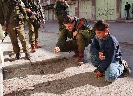 IDF Paratrooper plays with a Palestinian child in Gaza